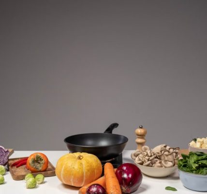 Studio composition of fresh vegetables and a frying pan, ideal for healthy cooking and recipe preparation.